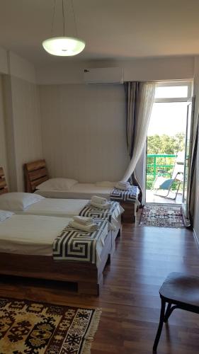 a bedroom with two beds and a sliding glass door at Apartment Alex II in K'obulet'i