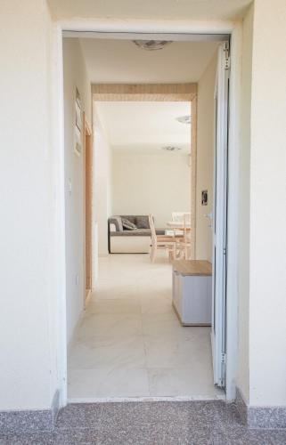 a hallway leading to a room with a bed at Apartmani Tripović in Tivat