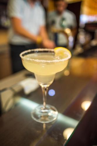 a martini glass with a lemon on a bar at Hotel Plamena Palace in Primorsko