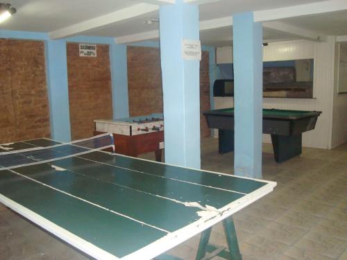 a ping pong table in a room with ping pong balls at Hotel Planalto in Poços de Caldas