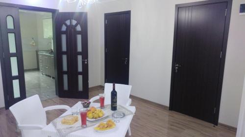 a table with a plate of food on top of it at Villa Royal House in Makhinjauri