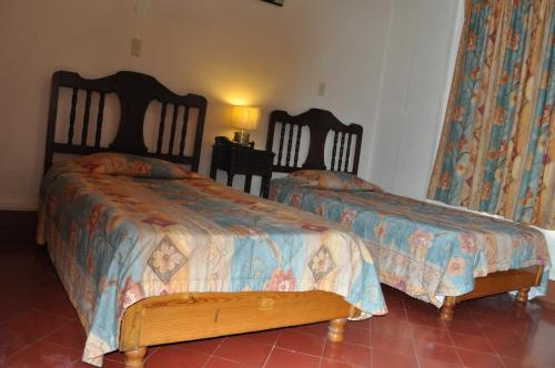 Una cama o camas en una habitación de Hotel 5a Avenida
