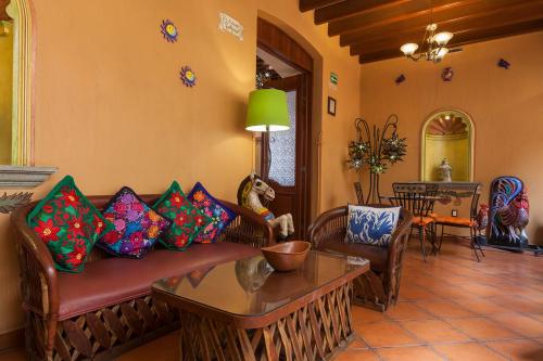 a living room filled with furniture and decor at Hotel Boutique Parador San Miguel Oaxaca in Oaxaca City