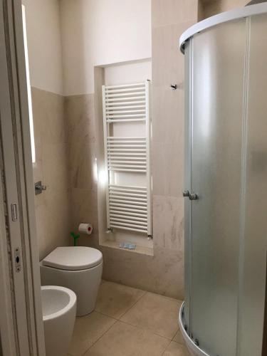 a bathroom with a shower and a toilet and a sink at Dimora di Charme Cassaro 168 in Marsala