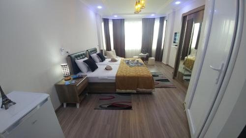 a bedroom with a bed with a yellow blanket on it at Villa Royal House in Makhinjauri