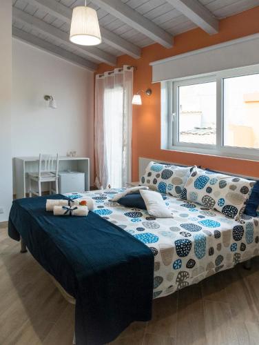 a bedroom with a large bed in a room at Casa Rossini in Ragusa