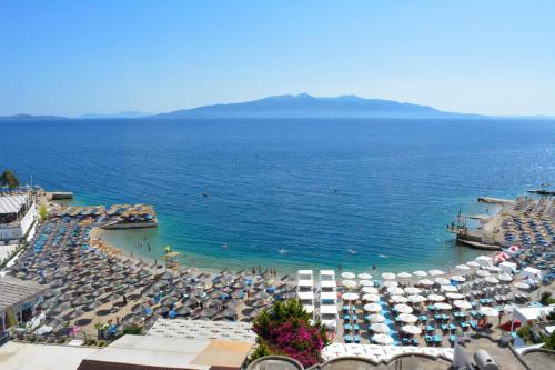 a view of a beach with umbrellas and the ocean at Epirus Hotel in Sarandë