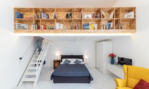 a loft bedroom with a bed and a staircase at Ecce Homo 28 in Naples