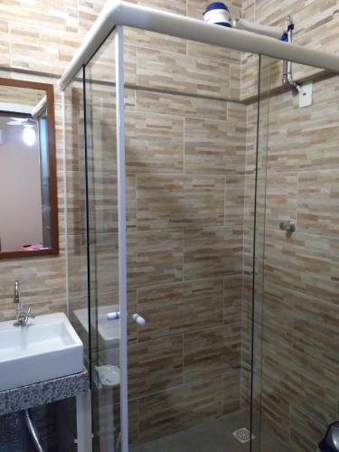 a bathroom with a shower and a sink at Aeropouso Pousada Executiva in Florianópolis
