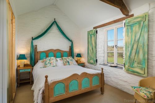 A bed or beds in a room at Trenderway Farm