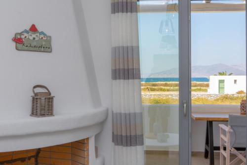 a bathroom with a sink and a view of the ocean at Salinus Beachfront Private Pool Villas in Plaka