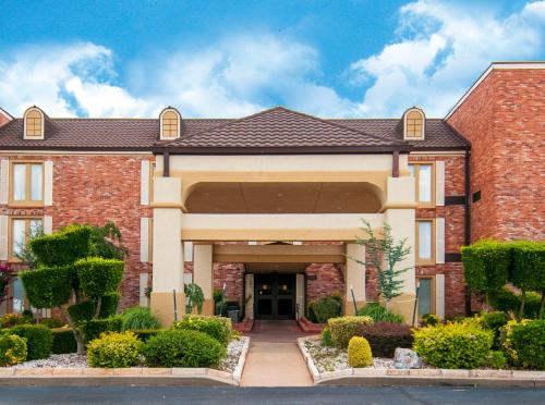a large brick house with a driveway at Governors Suites Hotel Oklahoma City Airport Area in Oklahoma City
