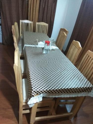 a table and chairs with a black and white checkered table and chairsuggest at Palay Shay Shay in Leh