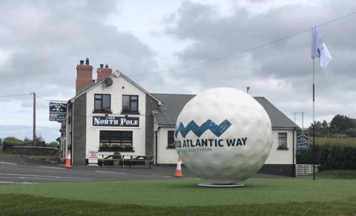 a large white ball on the grass in front of a building at The North Pole in Drumfree