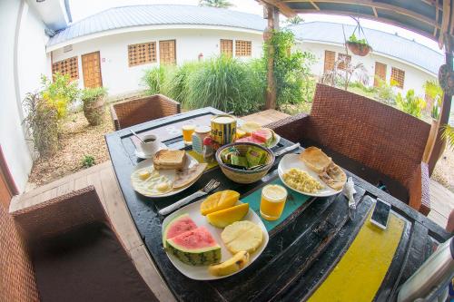 a table with a tray of breakfast foods on it at Nungwi House in Nungwi