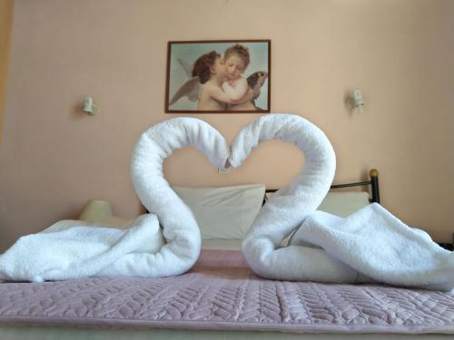 a bed with two swans in the shape of a heart at Amaranthos Skiathos View in Megali Ammos