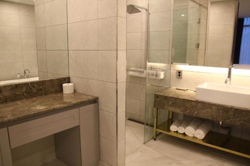 a bathroom with a sink and a mirror at AM Hotel in Pyeongchang 