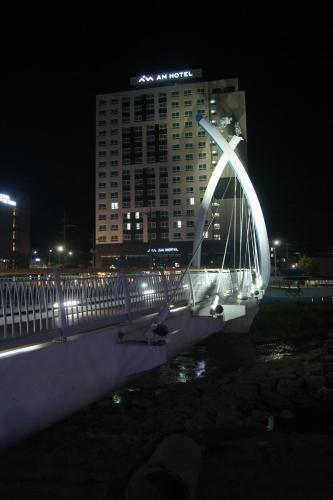 a bridge with a lit up arch in front of a building at AM Hotel in Pyeongchang 