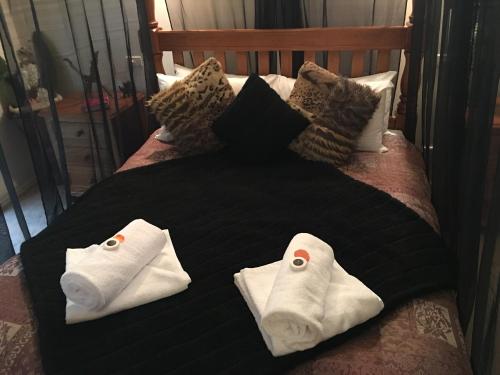 two towels on top of a bed with pillows at Weeroona Bed And Breakfast in Rye