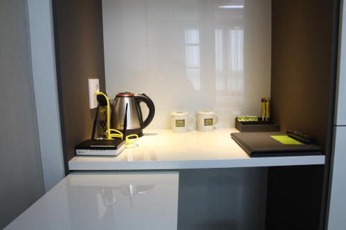 a kitchen counter with a tea kettle and other items on it at AM Hotel in Pyeongchang 