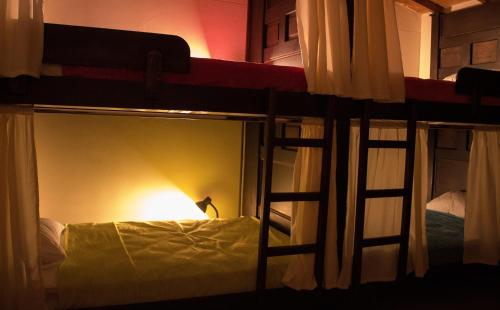 a room with two bunk beds with a light at Casa Azul Boutique Hostel in Pereira