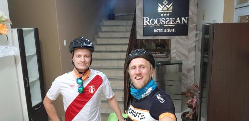 two men wearing helmets standing in front of stairs at Hotel Roussean in San Vicente de Cañete