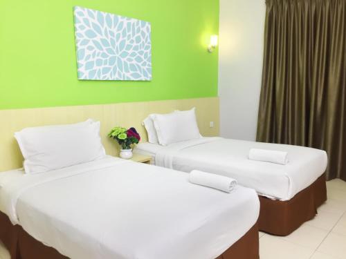 Ένα ή περισσότερα κρεβάτια σε δωμάτιο στο Temasek Hotel