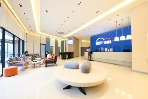 a lobby of a new inn with a couch and chairs at Hop Inn Hotel Alabang Manila in Manila