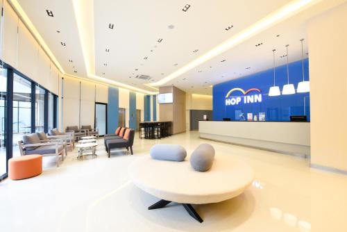 a lobby of a mcdonalds restaurant with a chair and tables at Hop Inn Hotel Alabang Manila in Manila