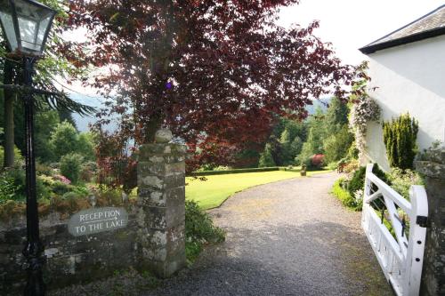 a path to the entrance to a house with a fence at Dale Head Hall Lakeside Hotel in Keswick