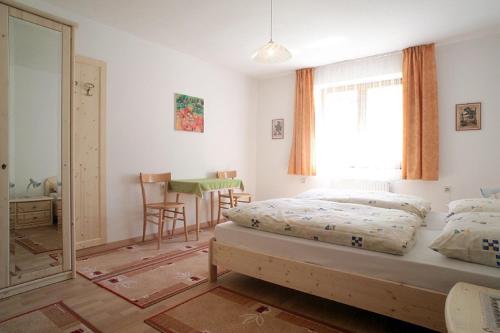 a bedroom with a bed and a window and a table at Ferienhaus Silvia in Martello