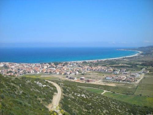 an aerial view of a town and the ocean at Sa Marina in La Caletta