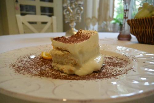 a piece of cake on a white plate on a table at Residenza Dutzu-Boutique Hotel in Brăila