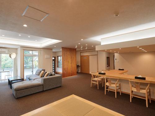 a living room with a couch and a table at ADAN RESORT Yuhina in Motobu