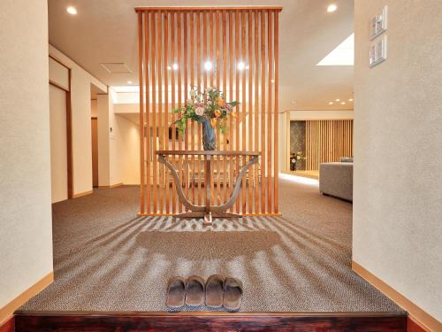 a lobby with a table with a vase of flowers at ADAN RESORT Yuhina in Motobu