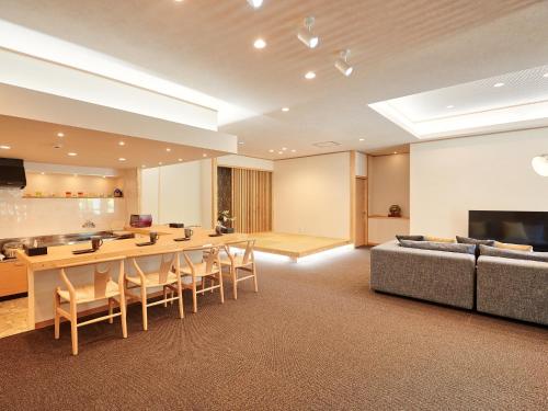 a large living room with a table and a couch at ADAN RESORT Yuhina in Motobu