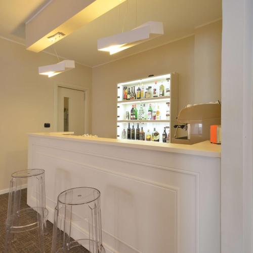 a bar with two stools and a counter with drinks at Best Western Hotel Crimea in Turin