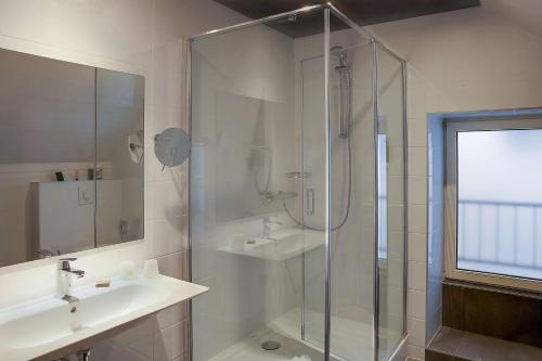a bathroom with a shower and a sink at Best Western Citadelle in Besançon