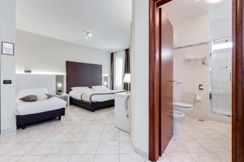 a hotel room with two beds and a bathroom at Best Western Hotel Rocca in Cassino