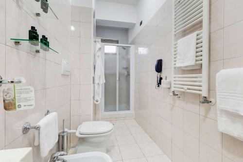 a white bathroom with a toilet and a sink at Best Western Hotel Rocca in Cassino