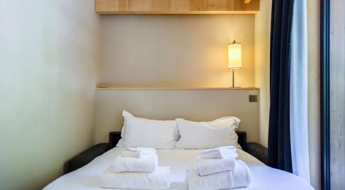 a bedroom with a bed with towels on it at Excelsior Chamonix Hôtel & Spa in Chamonix-Mont-Blanc