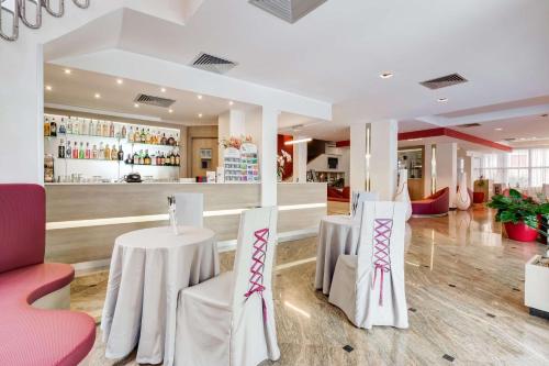 a restaurant with two tables and a bar at Best Western Hotel Rocca in Cassino