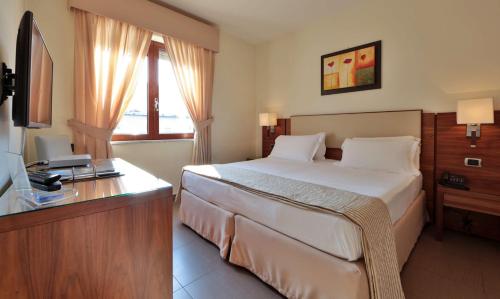 Postel nebo postele na pokoji v ubytování Suites & Residence Hotel