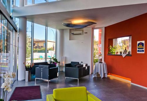 a lobby with couches and chairs in a building at Best Western Hotel Rome Airport in Fiumicino