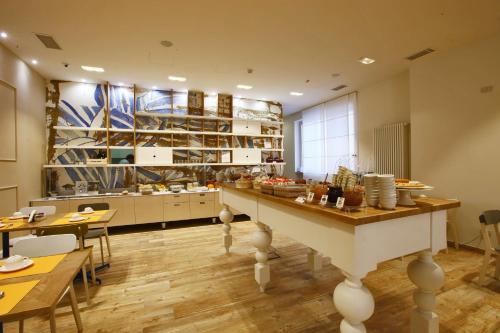 a large kitchen with a table in a room at Best Western Hotel Piemontese in Bergamo