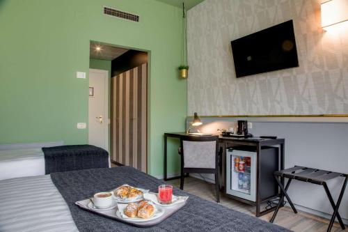 a hotel room with a table with two plates of food at Best Western Plus CHC Florence in Florence