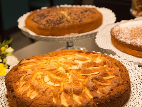 a pie sitting on a table with three cakes at Best Western Plus CHC Florence in Florence
