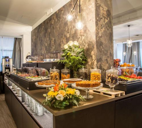 a buffet line with many plates of food at Best Western Plus CHC Florence in Florence