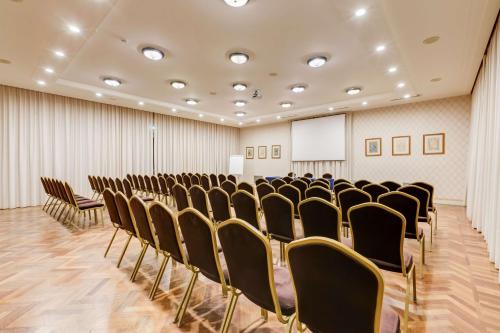 a conference room with chairs and a whiteboard at Villa Maria Hotel & SPA in Francavilla al Mare