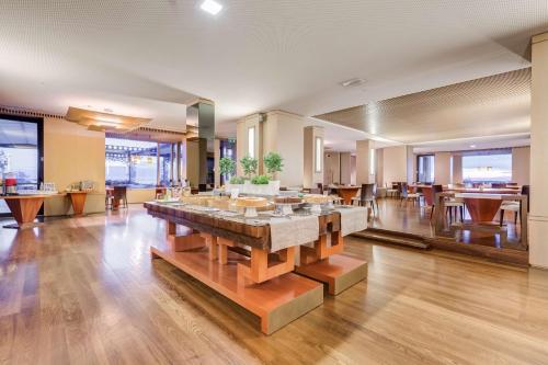 a lobby with a large table in the middle of a room at Villa Maria Hotel & SPA in Francavilla al Mare